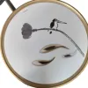 A white round tray with ink-wash birds perching on the branches is decorated with gold and silver metal spoons Item Picture